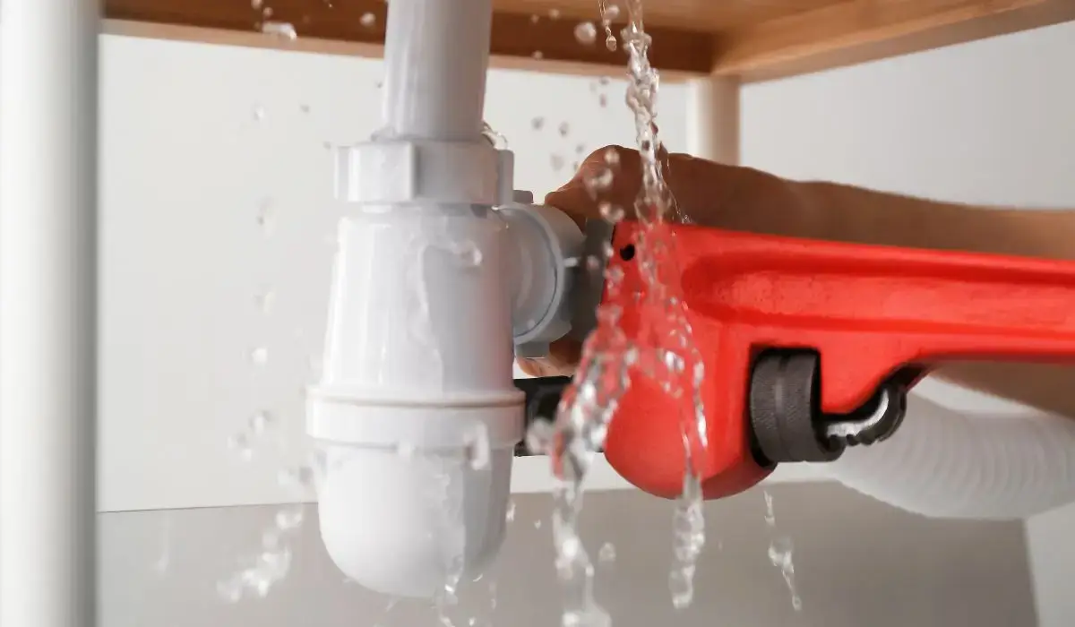 Emergency plumber repairing a water leak